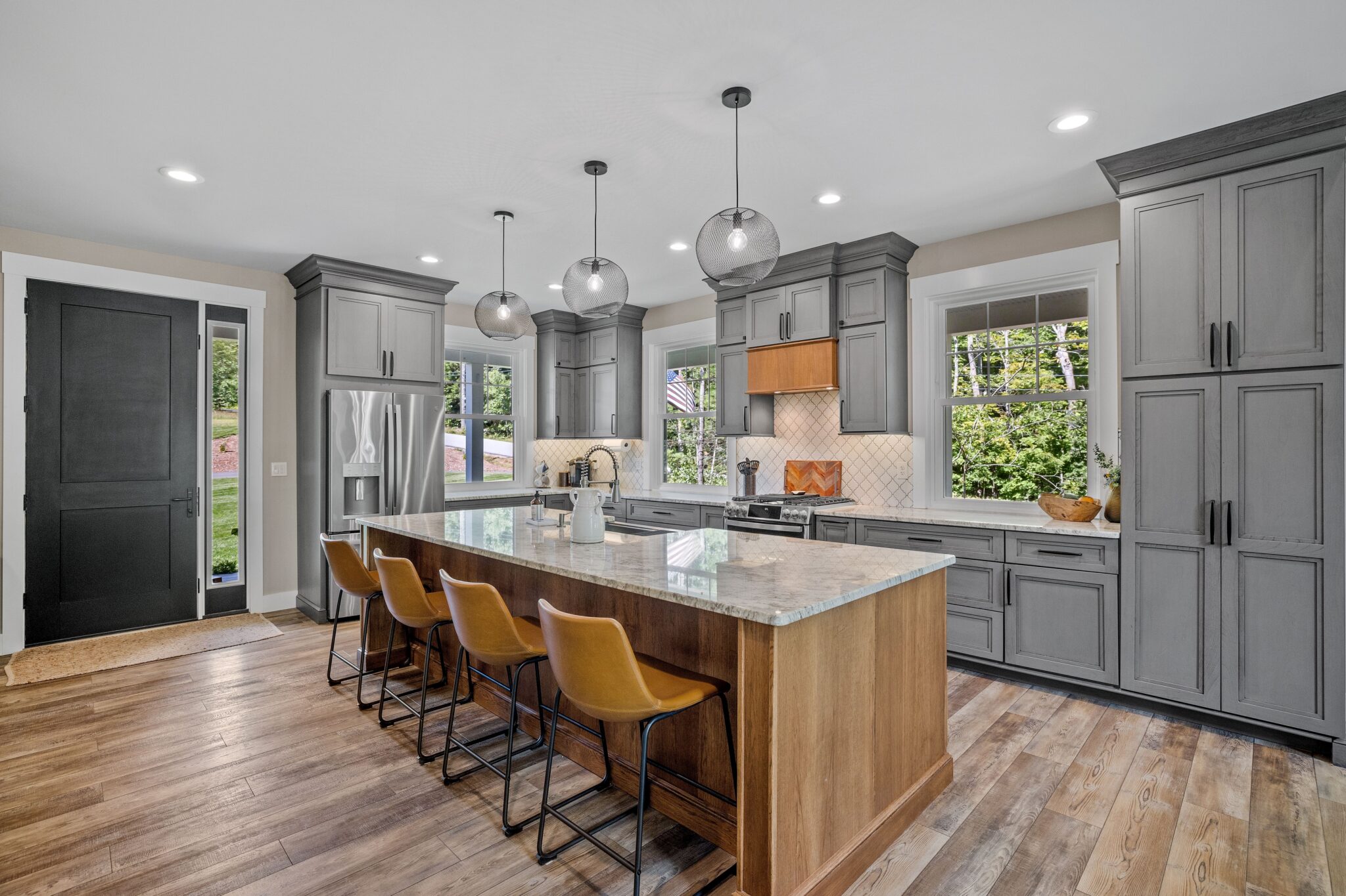 Interior design of a beautiful kitchen with a large island in a modern new England colonial home